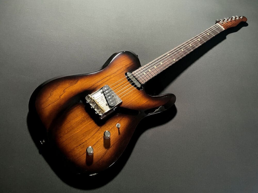 Elegant electric guitar with a sunburst finish, featuring a single cutaway, two knobs, and a sleek design, perfect for musicians and collectors.